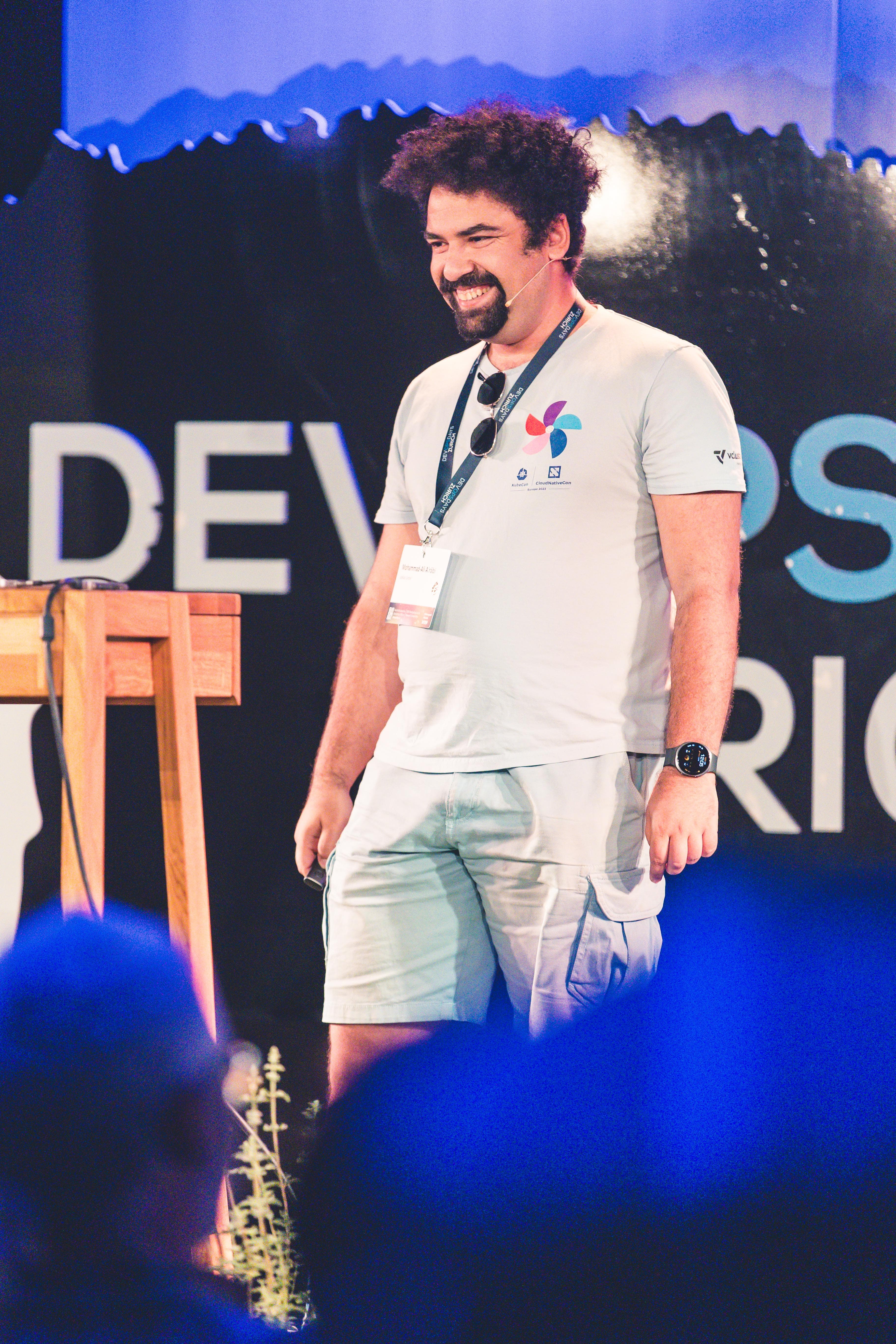Mohammad-Ali A'râbi presenting Beyond SBOMs on stage at DevOpsDays Zurich 2026.