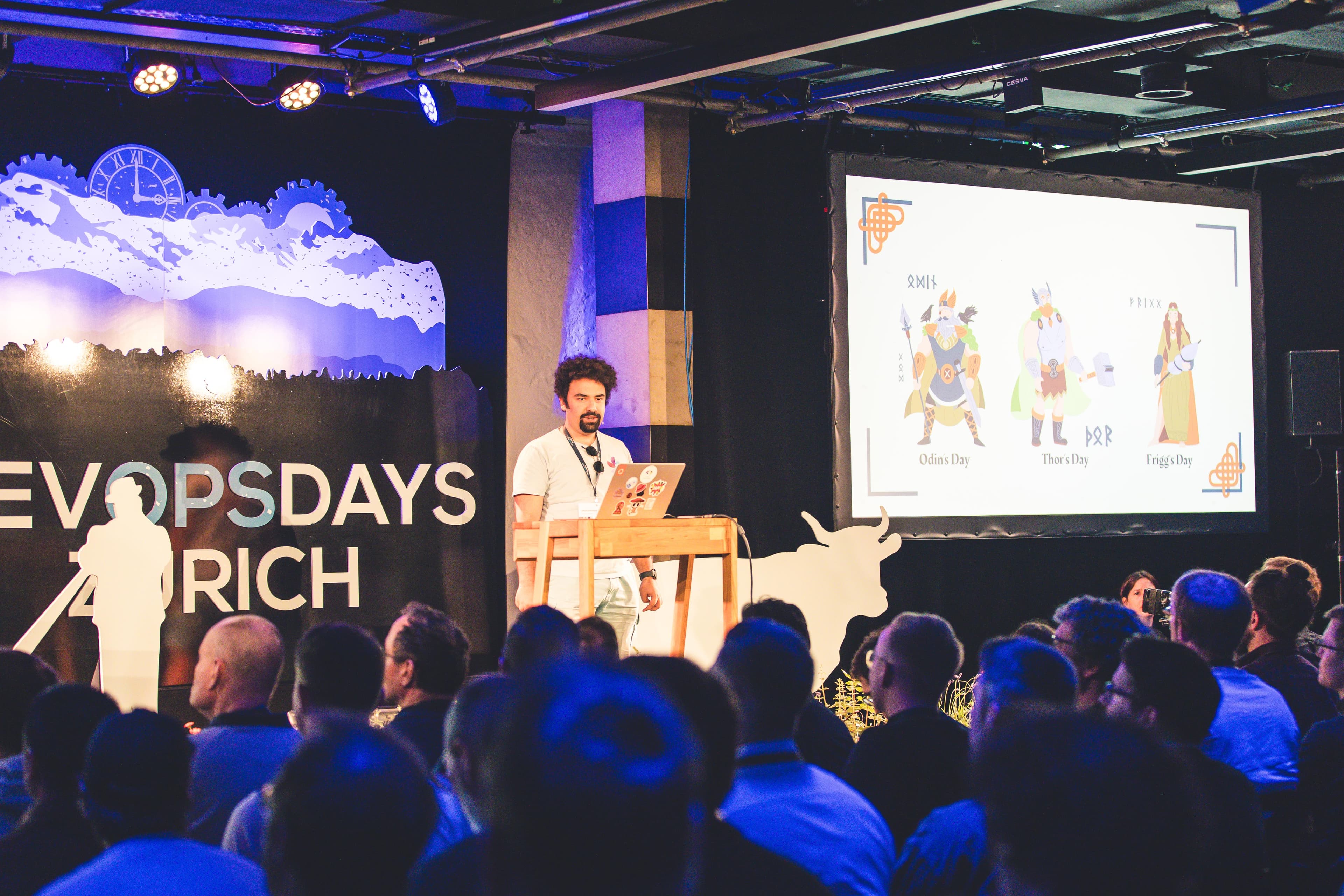 Stage view with Norse gods slide during Beyond SBOMs at DevOpsDays Zurich 2026.